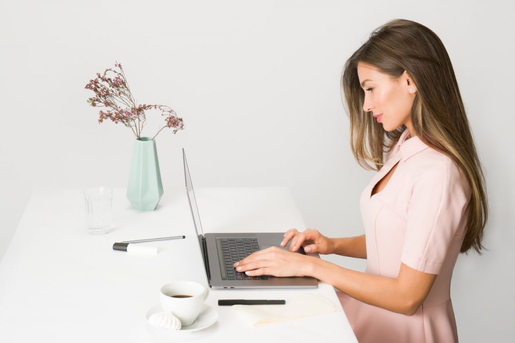 woman sitting at desk on computer