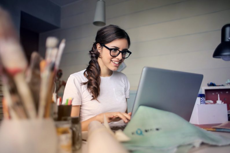woman on computer smiling